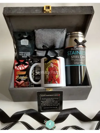 For the man who loves a sleek, monochrome aesthetic. This all black themed birthday hamper includes a stainless steel can, a custom photo mug, deep clean face wash, and his favorite chocolates.