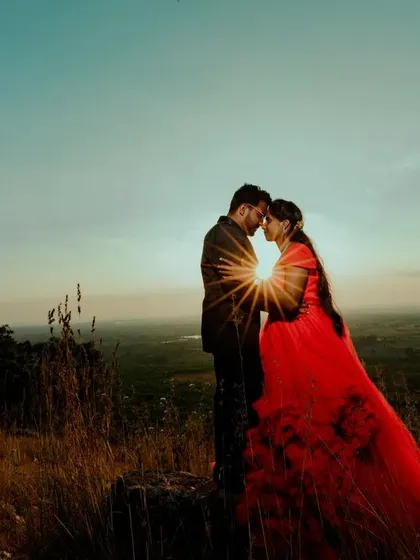 A duplicate of ID 128, capturing a breathtaking silhouette against a sunset, with the sun creating a perfect starburst between the couple.