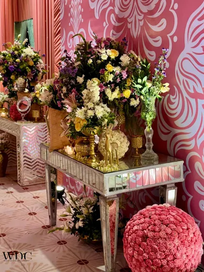Another angle of the mirrored console tables, showing how they reflect the light and flowers, amplifying the beauty of the decor.