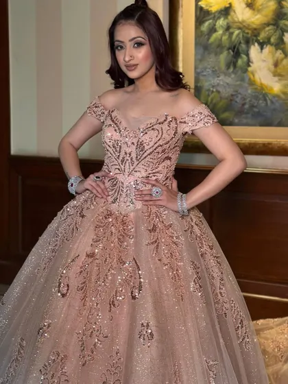 Another beautiful portrait in our rose gold ball gown, showcasing its versatility for photoshoots. The sparkling details and flattering silhouette ensure you look perfect from every angle.