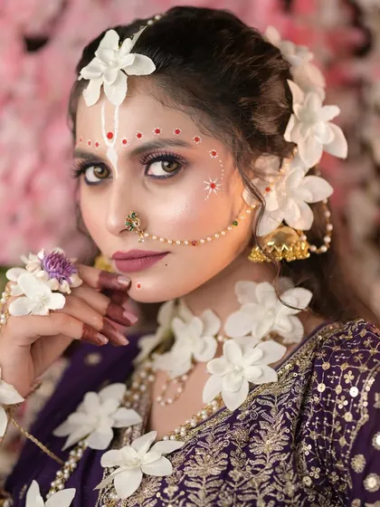 Makeup is an art form, and in my classes, we explore creativity. This is a close-up of a conceptual Radha look we created for Janmashtami, focusing on intricate details, soft makeup, and beautiful floral jewelry.