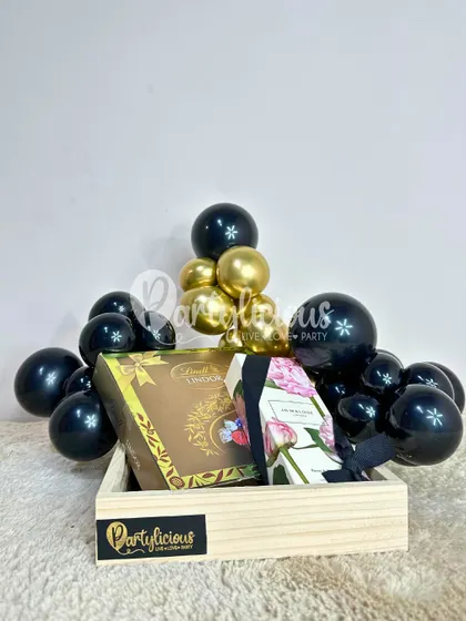 A chic and modern gift hamper styled in black and gold, proving that gift presentation can be as luxurious as the gift itself.