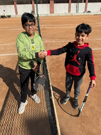 Even our youngest players learn the importance of sportsmanship. A handshake concludes a match in our junior category.