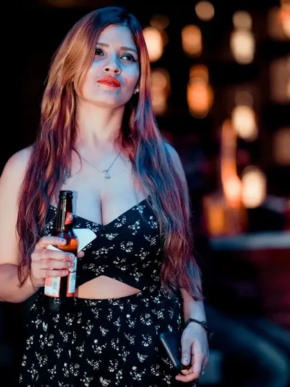 A guest enjoying a drink and taking in the vibrant nightlife scene.