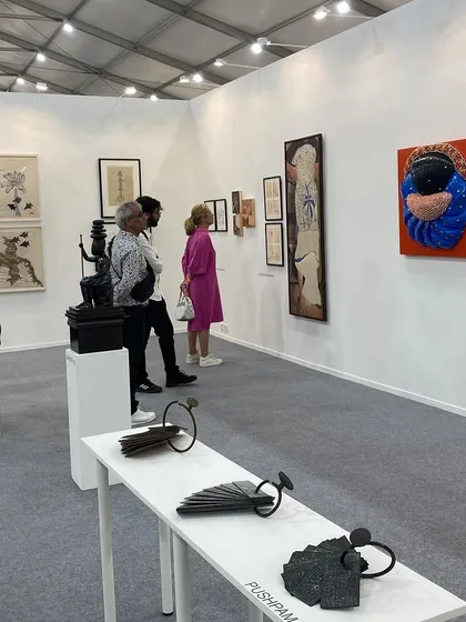 Visitors admiring the sculptures and paintings in our curated presentation.