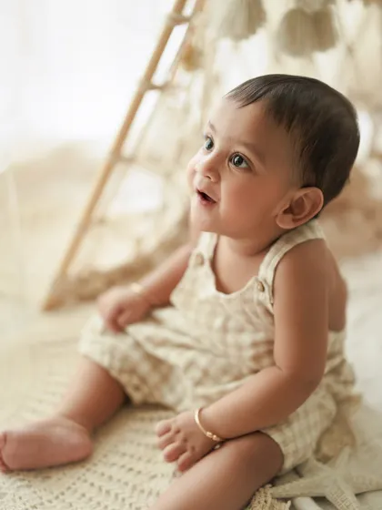 The sparkling innocence in those tiny, shining eyes. A close-up portrait is a must-have during a first birthday session to capture their sweet expressions.
