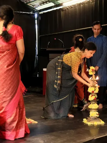 The traditional lighting of the lamp to begin the conference on puppet traditions. This ritual signifies the dispelling of darkness and the illumination of minds through shared knowledge and dialogue.