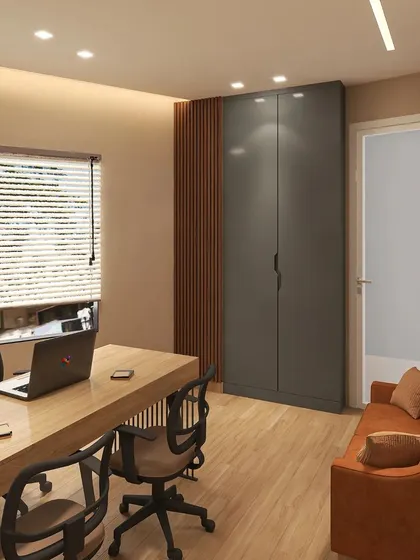 This view highlights the storage solutions and secondary seating in the Lajpat Nagar office. A full-height grey wardrobe offers ample concealed storage, while a comfortable sofa provides a space for breaks or informal meetings.