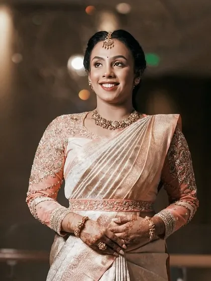 A full shot of the bride, showing how the custom blouse and matching belt create a cohesive and polished look.