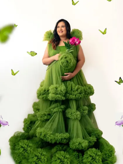A touch of whimsy with floating butterflies adds to the enchanting feel of this portrait in a stunning green gown.