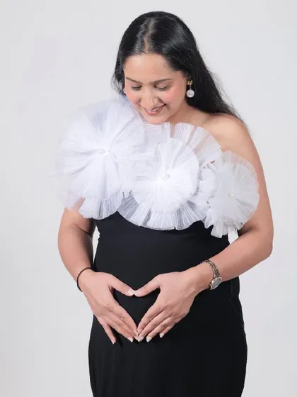 Our Veneccia gown is a classic black dress with a twist. The detachable white tulle flowers add a touch of modern, artistic flair.