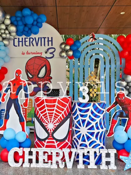 A web-slinging Spider-Man theme for Chervith's 3rd birthday. The setup is packed with action, featuring Spider-Man cutouts, web-patterned pedestals, and a red and blue balloon arrangement.