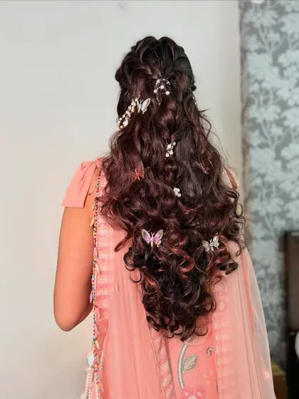 A full view of the beautiful butterfly-adorned hairstyle, perfect for a pre-wedding event.
