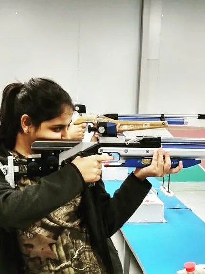 A young shooter demonstrates excellent form with her competition-grade air rifle. We focus on teaching the correct ergonomics and posture from day one.