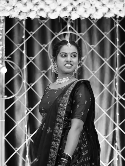 A black and white photo that highlights the intricate details of the client's attire and the backdrop's lattice design. Good decor looks great in any format.