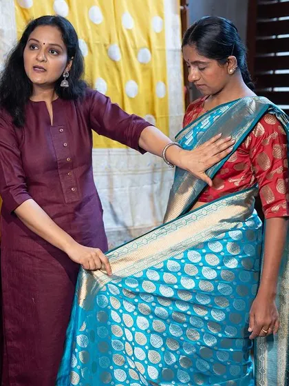 Adjusting the center pleats is a crucial step for a neat look. Here I am showing a student in my workshop how to align the pleats correctly before the final tuck.