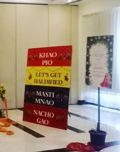 Fun and quirky signboards for a Haldi event, with phrases like "Khao Pio" and "Let's Get Haldi-fied" to entertain guests.
