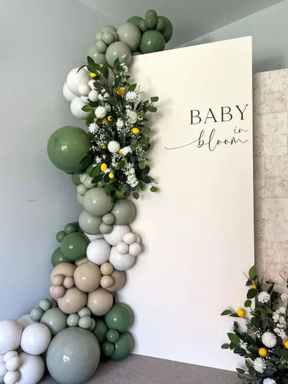A duplicate of the green and white "Baby in Bloom" setup, a popular and fresh theme for celebrating a new baby.