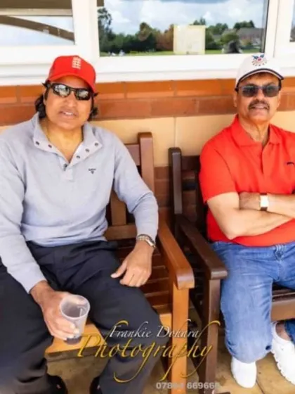 Watching a match from the players' bench with Rashid Patel. Even when relaxing, our focus is always on the game.