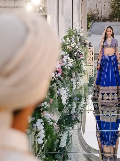 The bride's walk is a story in itself. Here, Shaan walks towards Shubham on a mirrored aisle in Istanbul, her reflection preceding her. We love composing these cinematic shots that feel like a scene from a beautiful film, capturing the anticipation and the grandeur.