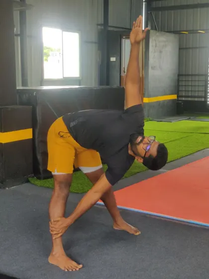 A standing triangle pose stretch. This is a fundamental yoga and flexibility exercise that we incorporate into our warm-ups and cool-downs.
