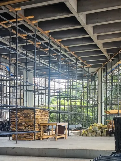 Site geometries at Office A in Hyderabad. The scaffolding creates a complex grid that echoes the waffle slab ceiling, revealing the building's structural logic.