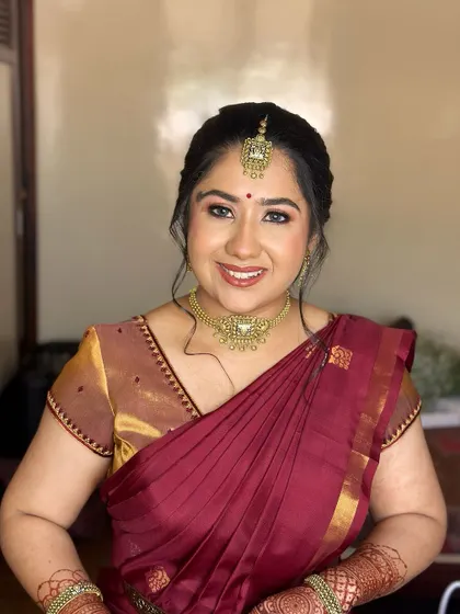 A portrait of a happy and beautiful bride-to-be. The makeup is kept fresh and glowing, with a focus on enhancing her natural features.