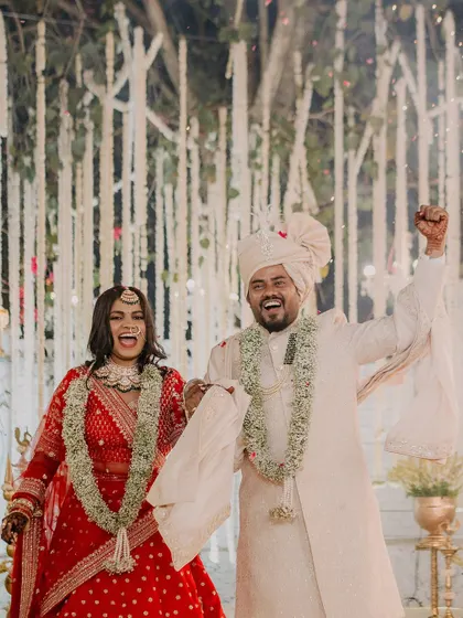 Pure happiness! This candid shot of the bride and groom during the varmala ceremony captures a moment of pure joy. Her makeup looks flawless and radiant.