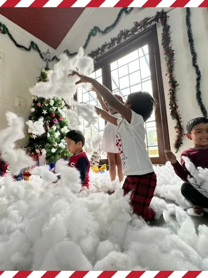 A playful "snowball" fight with cotton balls in our Christmas winter wonderland. It's all about creating joyful, sensory experiences for the children.