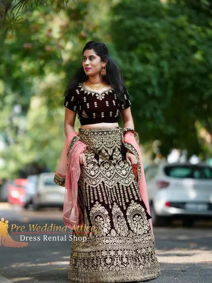 This outdoor shot captures the rich texture of the velvet and the sparkle of the gold embroidery in natural light.