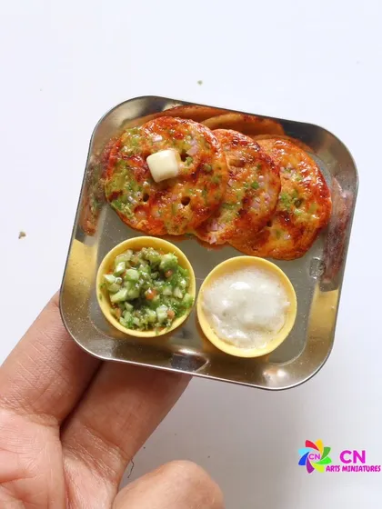 A miniature version of Thalipeeth, a savory multi-grain flatbread from Maharashtra, served with chutneys.