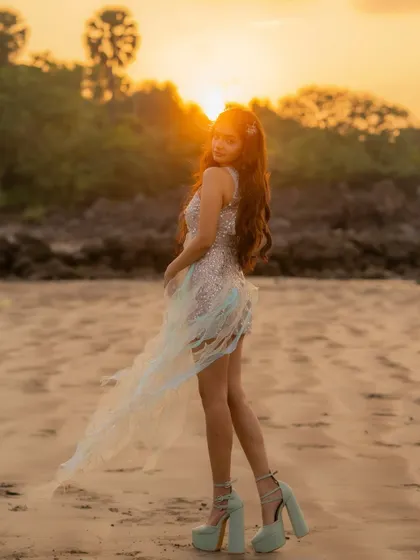 The custom music video dress in motion against the sunset. The lightweight, ethereal fabrics were chosen to catch the wind and light, adding a magical quality to the visuals.