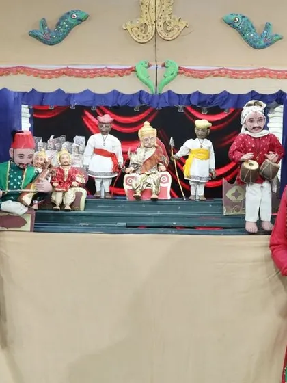 A shot of the traditional puppet stage with two actors, highlighting the blend of live acting and puppetry in our productions.