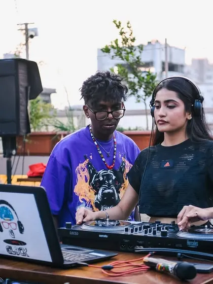 A daytime shot of a DJ spinning on the rooftop. Our Block Parties often start in the afternoon and go late into the night.