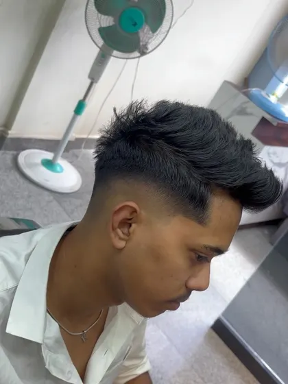 A textured haircut with a high fade for a young client.