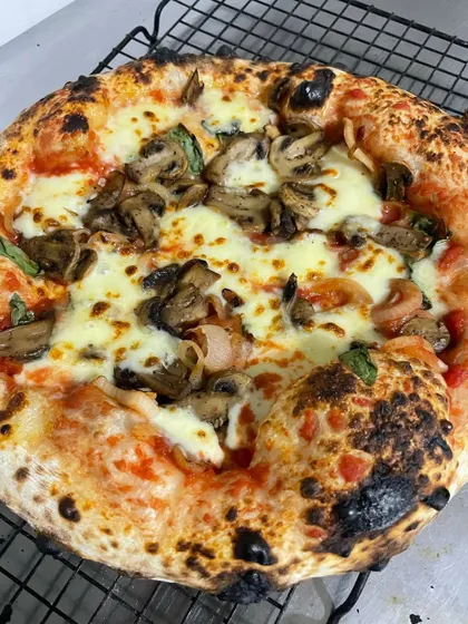 My Funghi pizza, featuring caramelized onions and savory mushrooms. The 72% hydration dough makes this pizza so light it practically melts in your mouth.