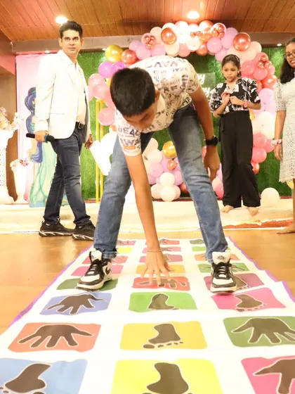 Another action shot of the popular hands and feet mat game, a favorite at kids' parties.