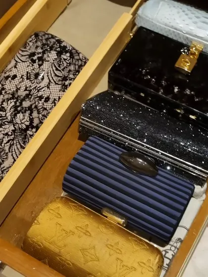 You don't need huge shelves to organize your clutches and small handbags. These images show how drawers with simple dividers can be the perfect home for your collection.