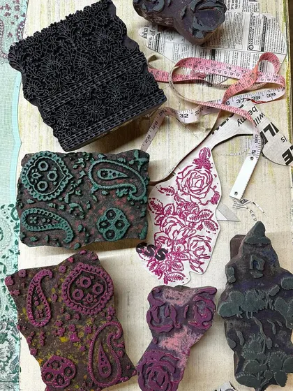 A flat lay showing the combination of vintage blocks and fabric swatches for a summer kota saree. We love mixing timeless floral and paisley prints to create a unique and dreamy aesthetic.