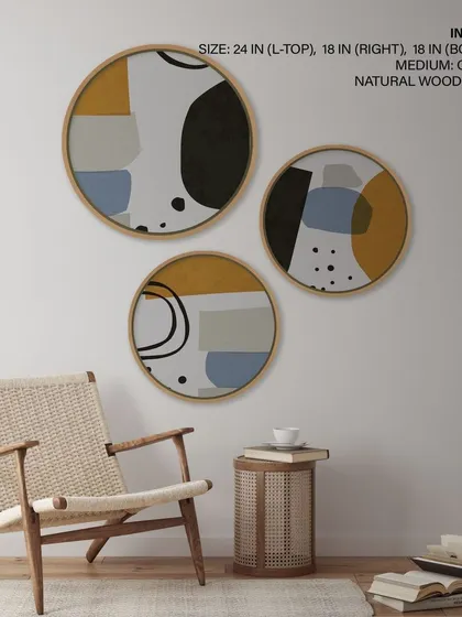 A set of three circular prints with abstract silhouette figures in a muted, contemporary palette. The natural wood frames add a touch of warmth to the minimalist, geometric designs.