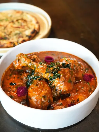 A winter indulgence. Our Methi Murgh features tender chicken cooked in a fenugreek-laced gravy, topped with pickled onions for a tangy kick.