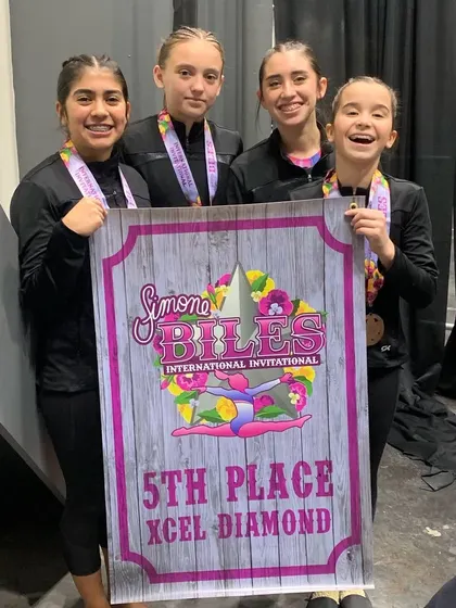 Our Xcel Diamond team celebrates their 5th place finish at the Biles Invitational. Every competition is a chance to shine, and these girls did just that.