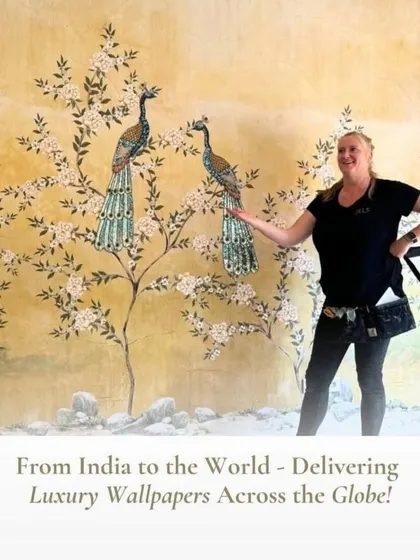 A client proudly showcases her new wall mural, featuring majestic peacocks on flowering branches, a design that brings luxury and tradition together.