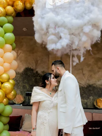 Another sweet moment from the 'Oh Baby' cloud-themed shower, framed by a beautiful balloon arch.