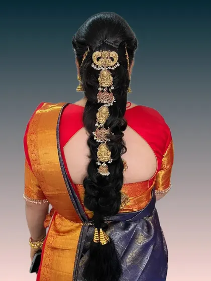 A modern fusion braid that incorporates traditional temple jewelry motifs in a contemporary layout. This is perfect for brides who want a unique twist on a classic style.