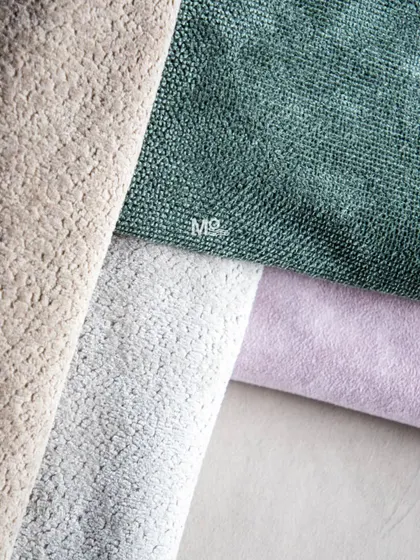 A close-up of our Easy Care fabric collection, showing the soft, skin-friendly textures in beautiful shades of beige, green, and lavender. These fabrics are durable and easy to clean.