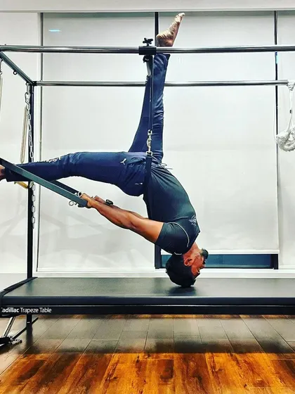 An unbending tree is easily broken. This advanced stretch on the Cadillac demonstrates the importance of flexibility for overall strength and resilience.