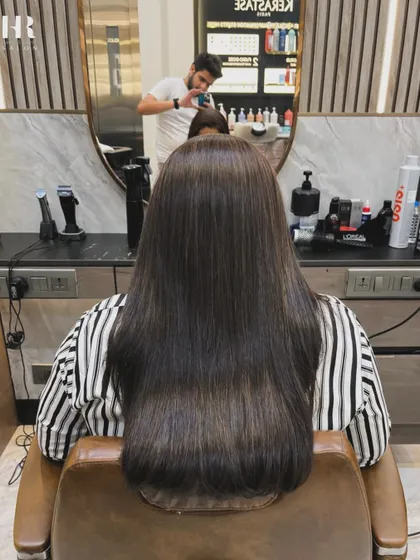 After the Hair Botox, her hair is incredibly smooth, straight, and glossy, seen here from the salon chair.