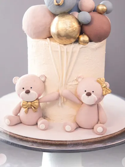 A close-up of the two sweet teddy bears holding hands, a perfect symbol of friendship for a birthday celebration.