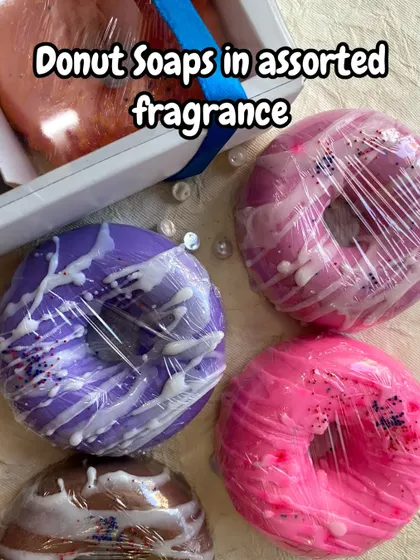 A collection of my donut soaps in assorted fragrances and vibrant colors like purple and pink. They are perfect for a themed gift box.
